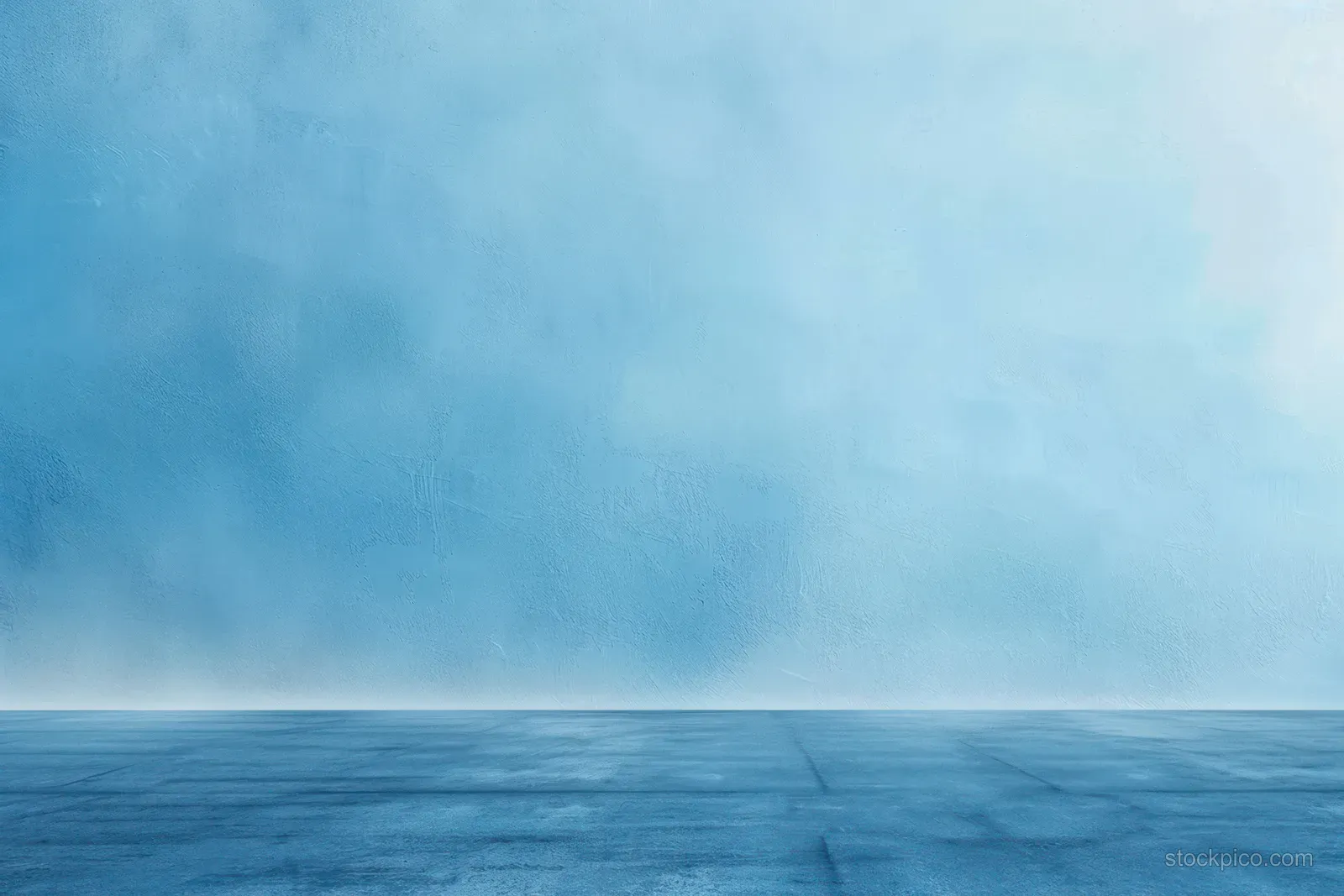 An empty blue concrete floor extends toward a softly textured blue wall with a subtle gradient.