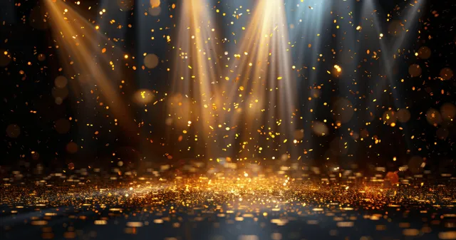 Golden confetti falls over dark awards stage with converging spotlight beams and empty space