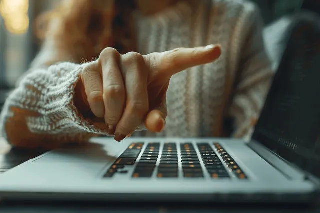 Woman’s hands typing on laptop at office desk, close-up with glowing keys with Remote Job Search