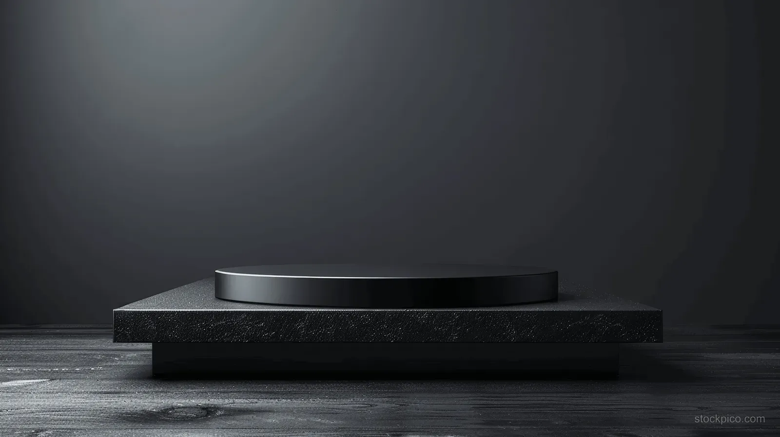 Black wooden shelf resting on a dark studio pedestal with a soft spotlight and empty background space.