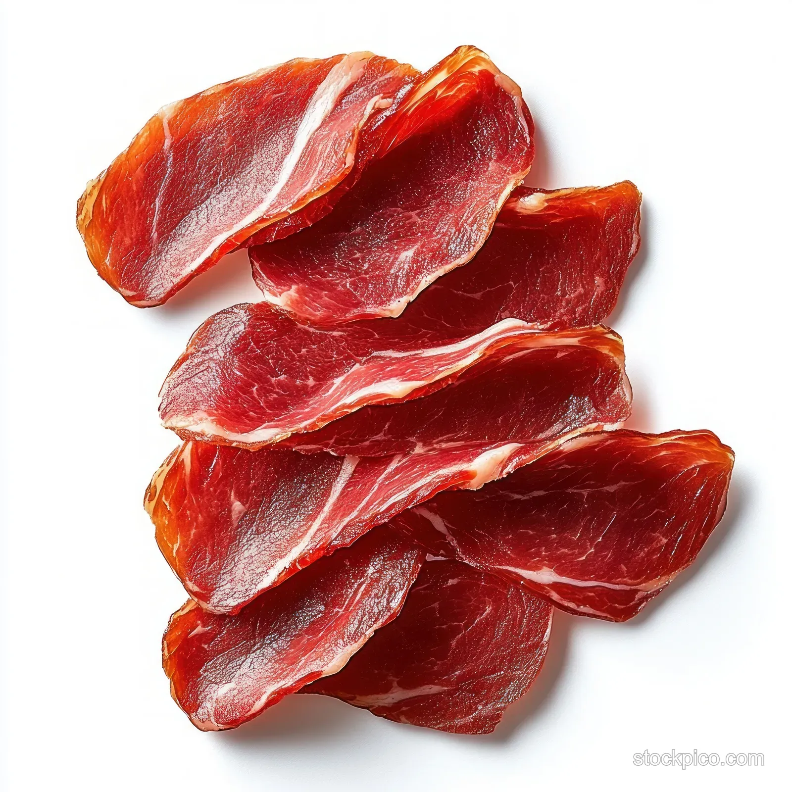 Stacked thin slices of cured red meat with visible marbling on a white background.
