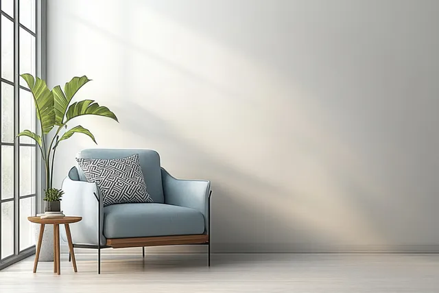 Light blue Scandinavian armchair with geometric cushions beside a wooden side table and potted plant in a bright empty room.