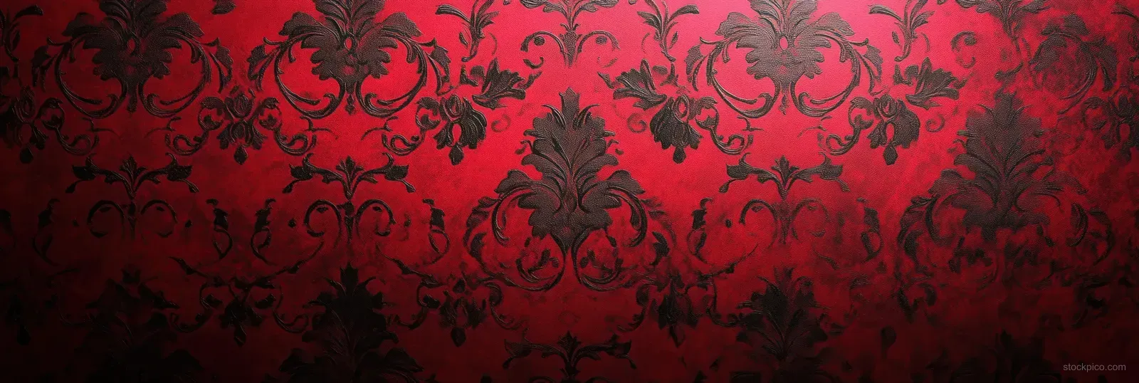 Red baroque damask wallpaper pattern with ornate floral motifs and subtle worn fabric texture.