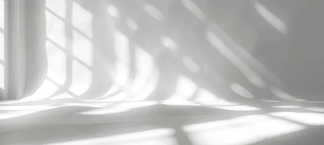 Sunlit white wall with striped window shadows and soft light gradients
