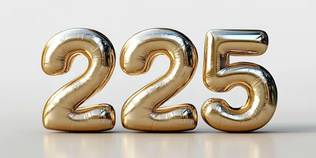 Shiny gold number balloons 2, 2, and 5 on a reflective studio surface