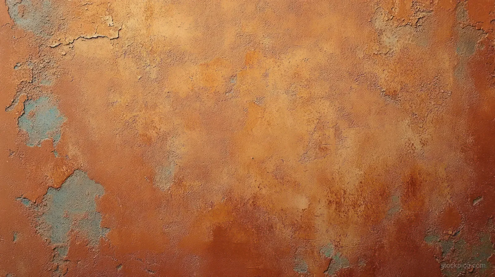 Close-up of a weathered wall where peeling paint exposes rust orange layers beneath faded blue patches.