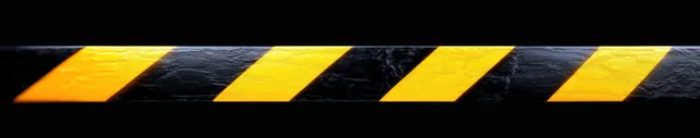 Black surface covered with diagonal yellow warning stripes with a glossy textured finish.