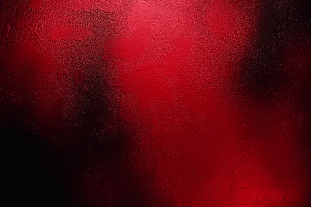 Dark red grainy gradient background with soft bokeh wave patterns