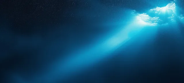 Abstract blue gradient backdrop with luminous light beam rays and subtle grain texture