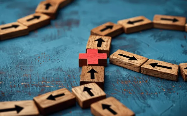 Wooden blocks arrows guide strategy, avoiding a red cross on a business planning board