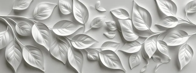 Close-up of raised white leaf and floral relief wallpaper on a textured wall surface with soft shadows.