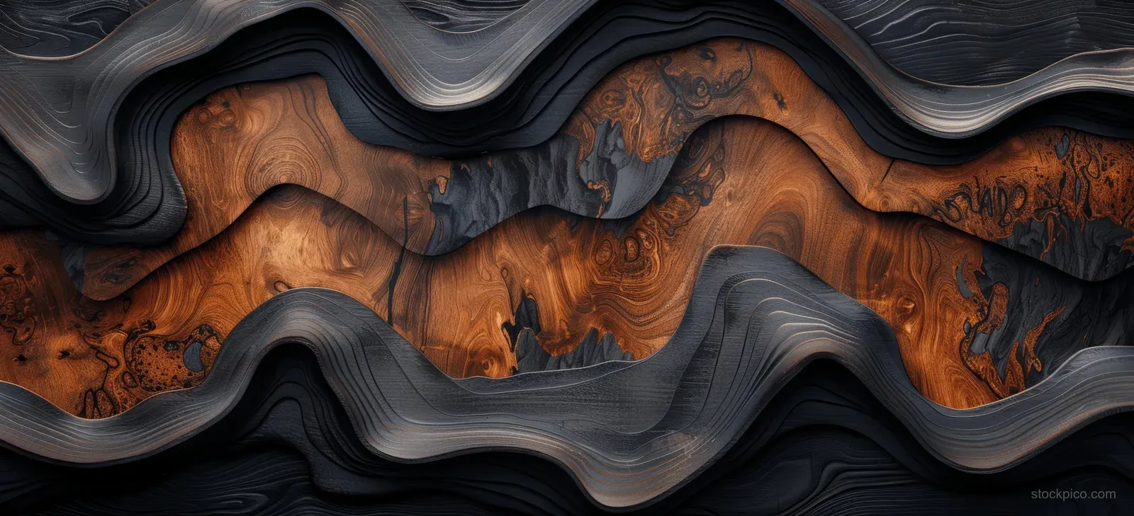 Layered dark wavy carvings on a weathered black-brown wooden background with visible grain texture.