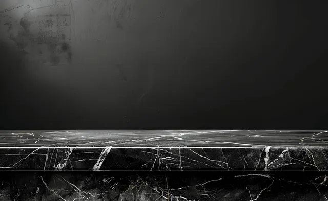 Black marble tabletop with white veining against a dark background.