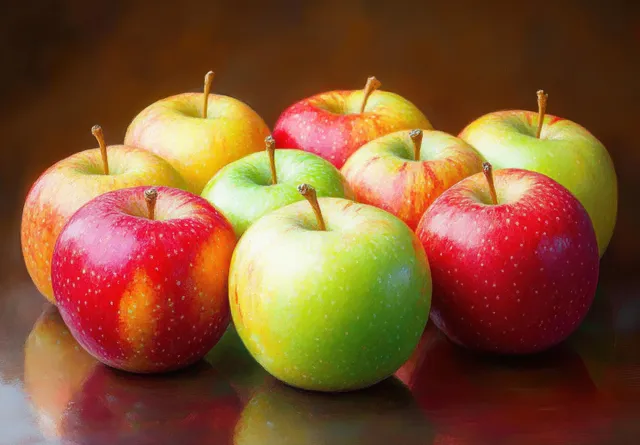 Red and green apples piled on a table with impressionistic color splashes
