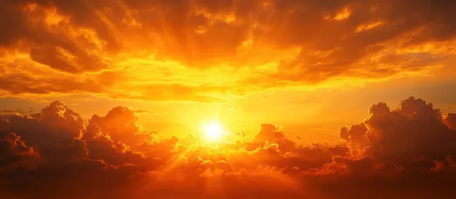 Golden sun shines through orange and yellow clouds at sunset, creating bright rays across the sky.