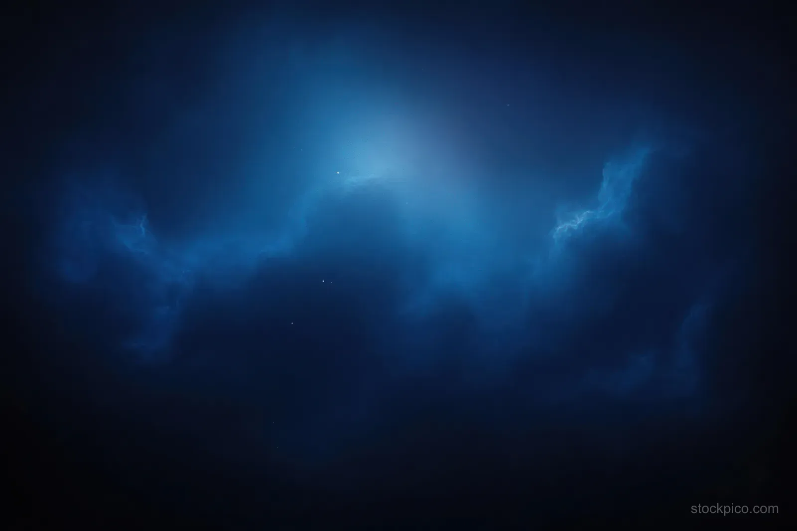 Deep blue nebula with glowing light rays and scattered stars in dark outer space.
