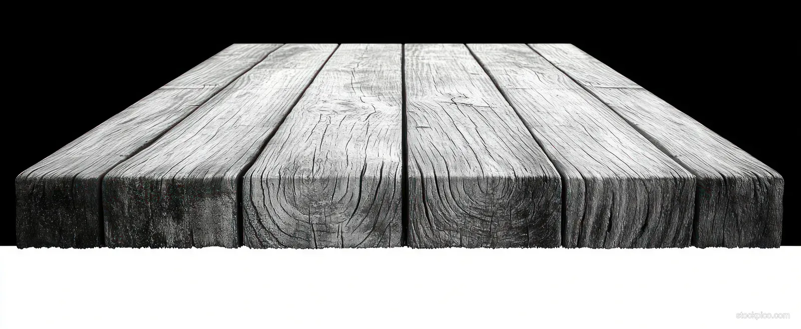 Weathered wooden planks with cracked grain framed against a black and white background.