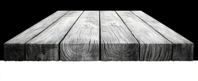 Weathered wooden planks with cracked grain framed against a black and white background.