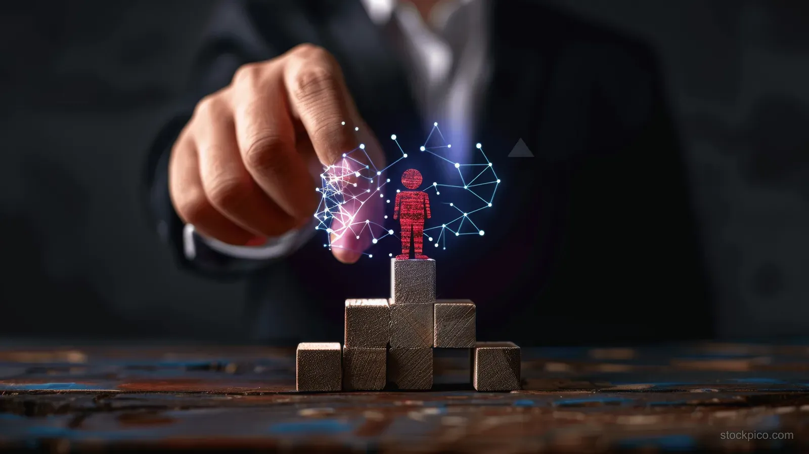 A hand places a red wooden figure on stacked wooden block stairs as glowing network icons hover above.