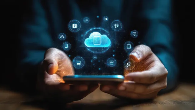Hands hold a tablet with a glowing cloud ERP interface and connected business icons.