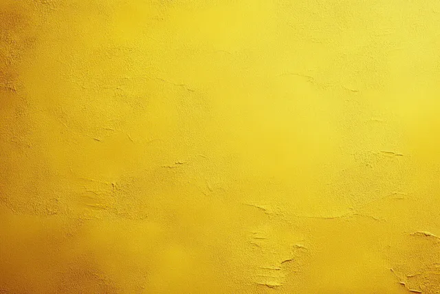 Close-up of a bright yellow rough plaster wall with uneven patches and grainy surface texture.