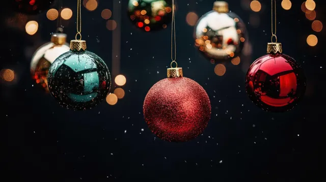Hanging Christmas ornaments with glittery baubles against dark snowy backdrop