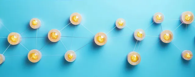 Wooden discs connected by white strings form a connected node network across a blue background.