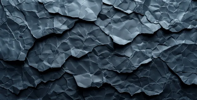 Black crumpled paper texture background with folded wrinkles and empty copy space