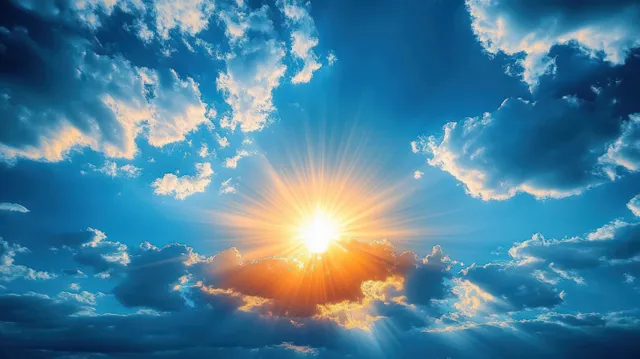 Sunburst shining through scattered clouds in a vivid blue sky