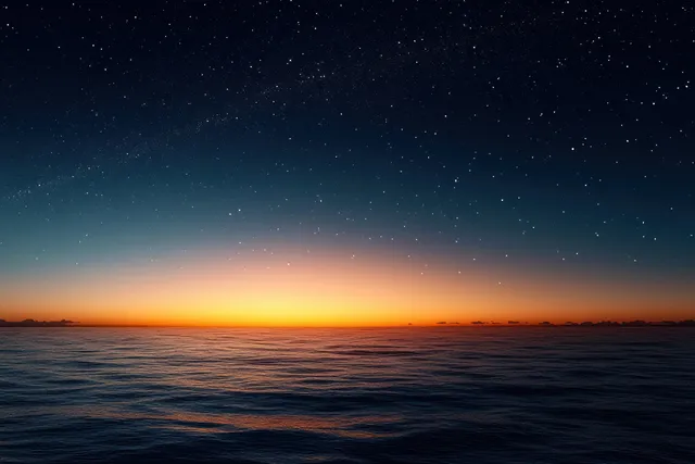Twilight ocean horizon with an orange glow and a dark sky scattered with visible stars.
