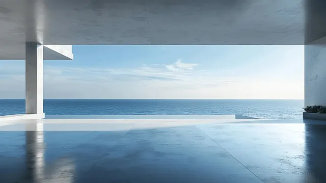 Empty concrete terrace interior frames a car display area with ocean horizon outside under blue sky.