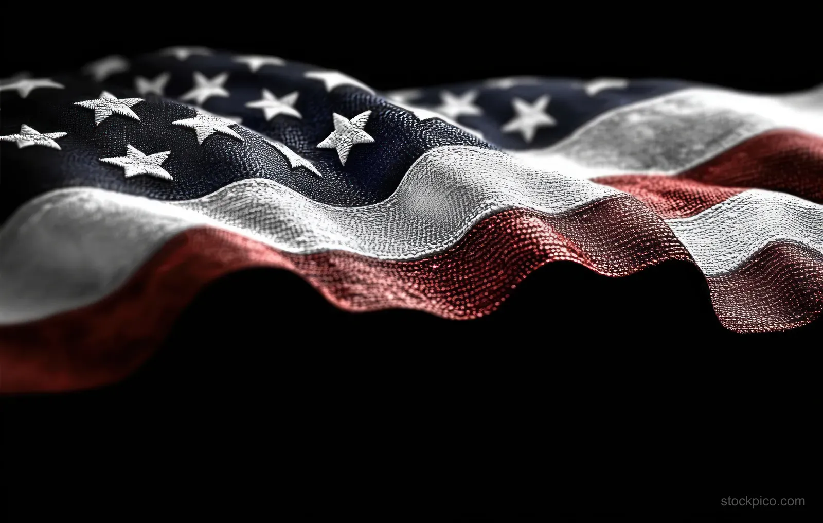 A close-up of a star and stripe fabric waving with textured folds against a dark background.
