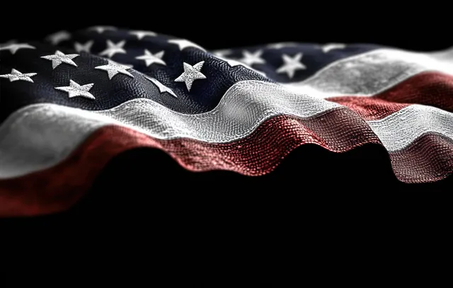 A close-up of a star and stripe fabric waving with textured folds against a dark background.