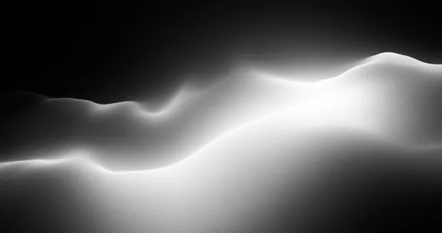 Black and white gradient wave glow drifting across a smooth minimalist dark background