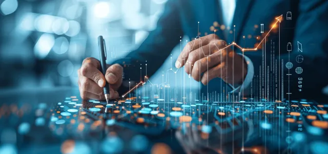 Hands interacting with a tablet as a glowing upward investment chart and data overlays appear over a blurred finance scene.