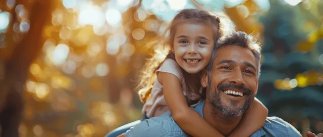 Smiling Father Lifting Daughter on a Piggyback Ride in Sunny Park