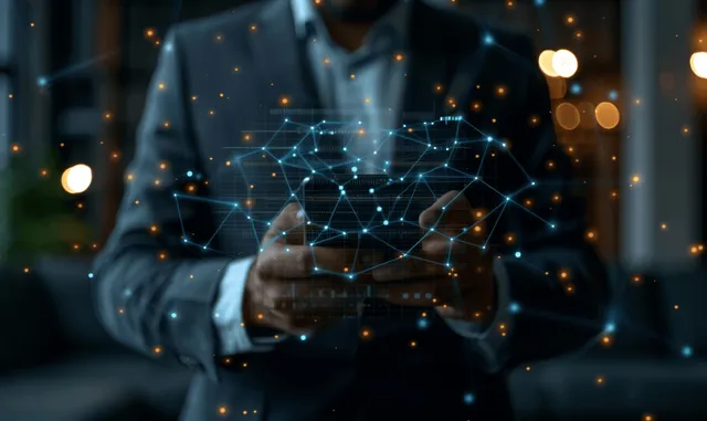 A businessman holds a smartphone as digital currency and investment icons float over a dark financial background.