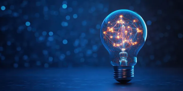 An illuminated light bulb shows a glowing interconnected network inside against a dark blue bokeh background.