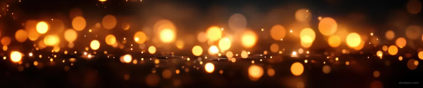 Warm golden bokeh lights glow softly across a dark horizontal festive background.