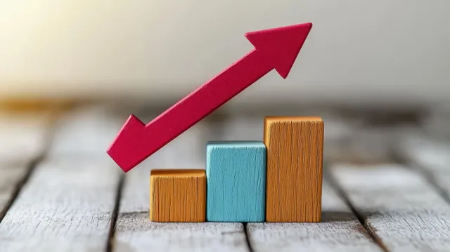 Colorful wooden blocks stacked like a rising bar chart under a red upward arrow