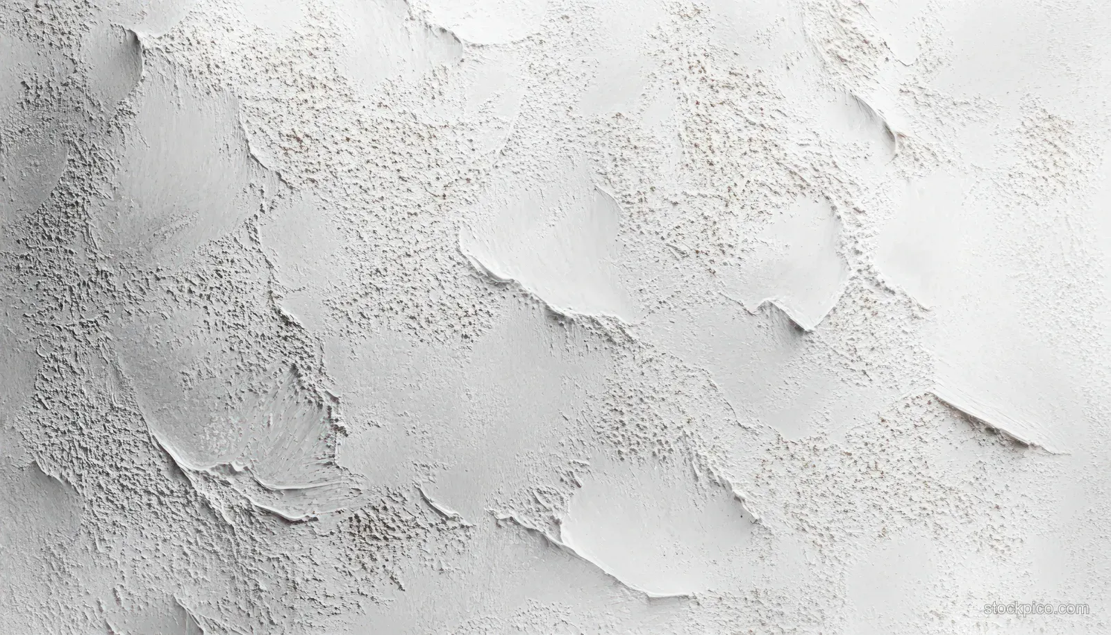 Close-up of a white plaster texture wall with soft shadows and irregular raised organic patches.