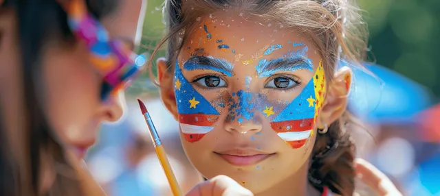 Young girl with USA flag star face paint smiles beside her mother during a sunny street festival.
