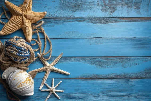 Starfish, seashells, driftwood, and fishing net rest on weathered blue wooden boards in a nautical still life.