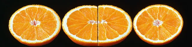 Three orange slices arranged horizontally on a black background, showing juicy pulp texture and bright zest.