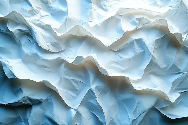Light blue crumpled paper background with deep creases, folded waves, and soft shadows.