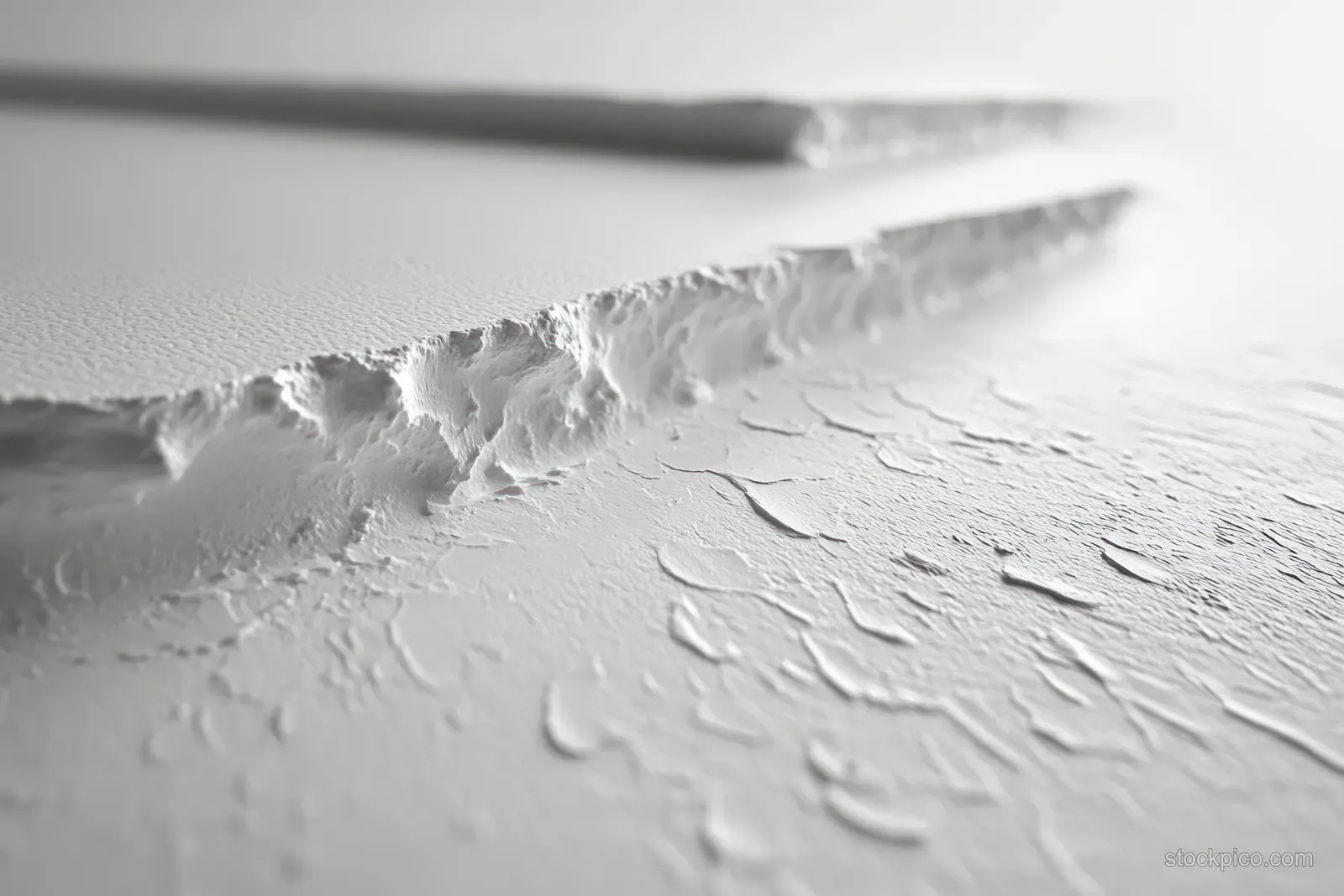 Torn white paper surface with detailed creases and subtle fibers under soft, diffused light.