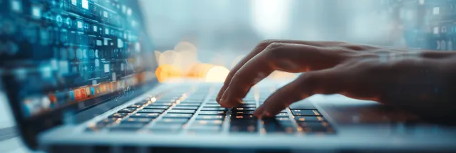 Woman Typing on Laptop Keyboard in Office with Soft Natural Light