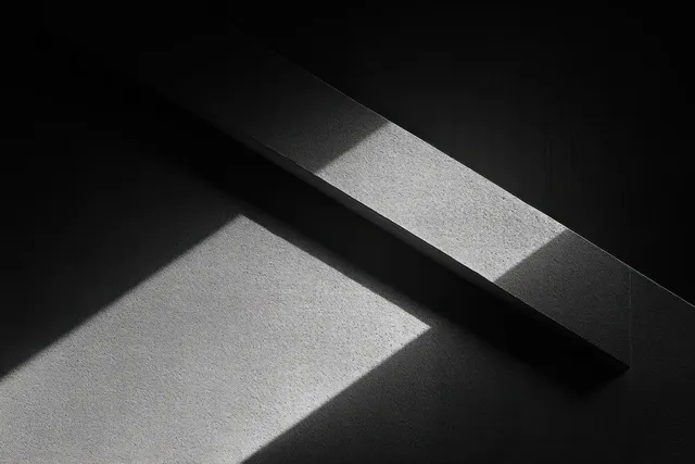 Monochrome concrete wall detail with a dark diagonal bar and sharp shadows across textured surfaces.
