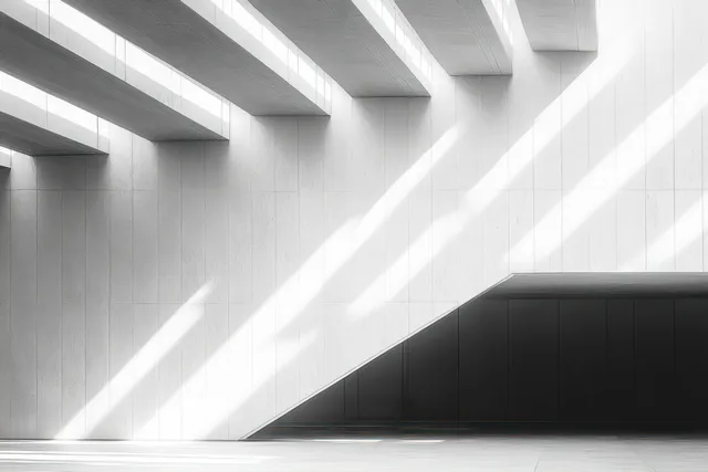 White interior ceiling beams cast diagonal shadows onto a sleek black geometric wall panel.