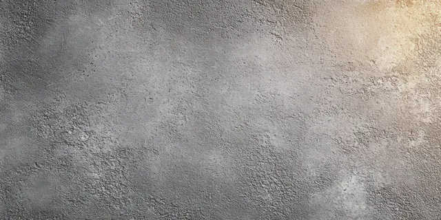 Close-up of a rough gray concrete wall surface with subtle shadows emphasizing the gritty texture.
